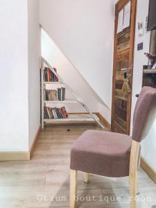 a living room with a chair and a staircase at Otium Boutique Room in Pai