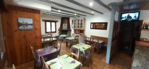 a restaurant with tables and chairs in a room at Le Perce Neige d'Alicia in Sainte-Foy-Tarentaise