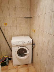 a small bathroom with a washing machine in it at Sporta 2 in Daugavpils