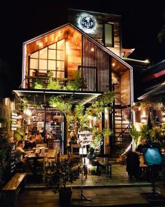 a restaurant with people sitting at tables outside at night at Otium Boutique Room in Pai