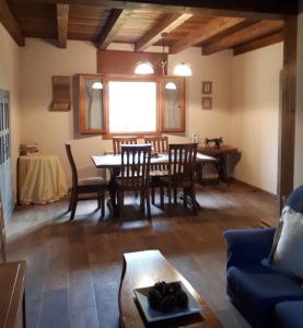 a living room with a table and chairs and a couch at La Zamarriega in Segovia