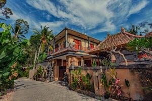 a large house with a balcony on top of it at SARI SEDANA HOME STAY in Gianyar