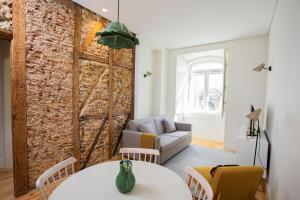 a living room with a couch and a table at Montebelo Lisbon Downtown Apartments in Lisbon