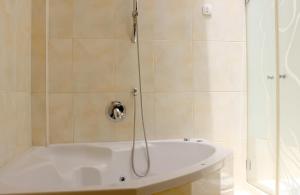 a bathroom with a shower with a bath tub at Rachel imenu Duplex Apartment Amazing sea view in Ashdod +21 photos