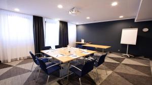 a conference room with a long table and chairs at Holiday Inn Express - Saarbrücken by IHG in Saarbrücken