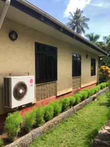 a house with a fan on the side of it at Tatys homestay in Dar es Salaam