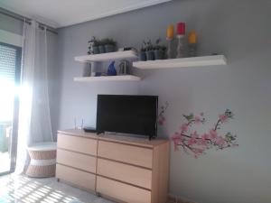 a living room with a tv on a dresser at Apartamento LAVANDA , Costamarina, Cabo Roig in Orihuela Costa