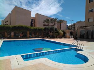 a large swimming pool in front of a building at Apartamento LAVANDA , Costamarina, Cabo Roig in Orihuela Costa