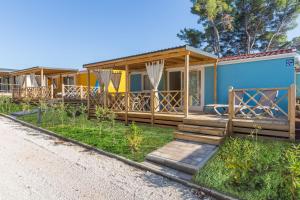a row of modular homes on the side of a road at Camping Adria Mobile Homes Lanterna in Poreč