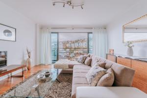 a living room with a couch and a table at Cozy T2 with Ocean View in Funchal