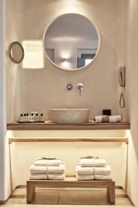a bathroom with a mirror and a sink at Mykonos Bliss - Cozy Suites, Adults Only Hotel in Kalo Livadi