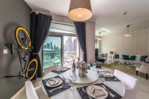 a dining room with a table and a bike on the wall at Divine Burj & Opera Views - 2BDR - DOWNTOWN DUBAI in Dubai