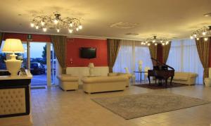 a living room with a couch and a piano at Hotel Madonna Delle Grazie in Ceglie Messapica