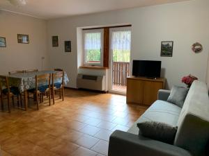 a living room with a couch and a table at Le Fontanacce b&b in Vezza dʼOglio