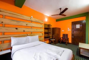Postel nebo postele na pokoji v ubytování Hotel Pomelo House Inn