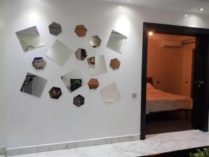 a wall with several pictures on it with a bed at Franklin in Casablanca