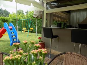 a backyard with a playground with a swing at Alisachni in Paralia Panteleimonos