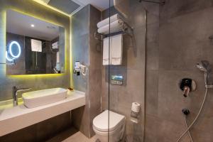 
a bathroom with a toilet, sink, and shower stall at Nova Plaza Crystal Hotel & Spa in Istanbul
