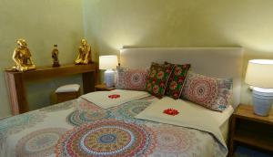 a bedroom with a bed with pillows and two statues at DOMAINE VILLA PRIVE in Marrakesh