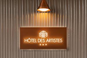 a sign for a hotel des antilles hanging on a wall at Hôtel Des Artistes in Lyon