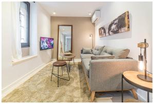 a living room with a couch and a table at Apartamentos Madrid Rio in Madrid