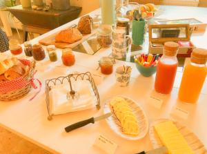 a table topped with plates of food and orange juice at Domaine de Rochebelle in La Cadière