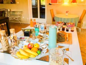 a table with a plate of fruit and other foods at Domaine de Rochebelle in La Cadière