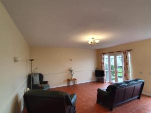a living room with two chairs and a couch at Ingoldale Park Apartments in Ingoldmells