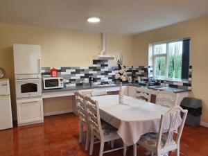 a kitchen with a table and chairs in a kitchen at Ingoldale Park Apartments in Ingoldmells