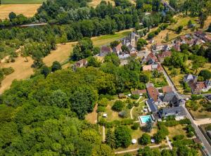 an aerial view of a small town with houses and trees at Le Prieuré L´Atelier in Lanzac +7 photos
