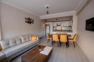 a living room with a couch and a table and chairs at LOTUS HOME SAPANCA in Sakarya