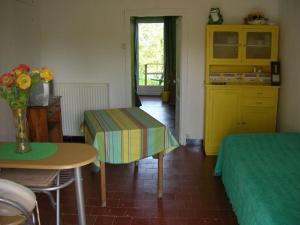 Zimmer mit 2 Betten und einem Tisch mit einer Blumenvase in der Unterkunft Gîtes Ermitage Saint Romble in Crézancy