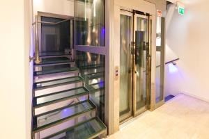 a staircase with glass treads in a hallway at Residence Lenno in Lenno