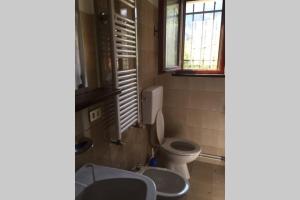 a bathroom with a toilet and a sink at Casa Vacanze Almades in Almàdis