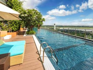a swimming pool on top of a building at Ibis Saigon Airport in Ho Chi Minh City