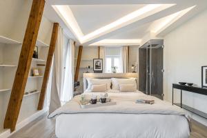 Säng eller sängar i ett rum på Le Dortoir Boutique Suites