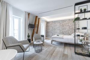 Säng eller sängar i ett rum på Le Dortoir Boutique Suites