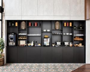 a kitchen with a counter with aasteryasteryasteryasteryasteryasteryasteryasteryastery at New Hotel Le Quai - Vieux Port in Marseille