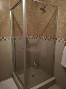 a shower with a glass door in a bathroom at Rocky Ridge Guest House 2 SELF CATERING - No Alcohol allowed in Roodepoort