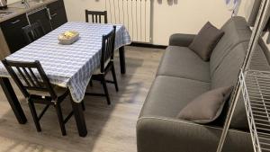 a living room with a table and a couch at Studio CENTRAL 2 in Aosta +10 photos