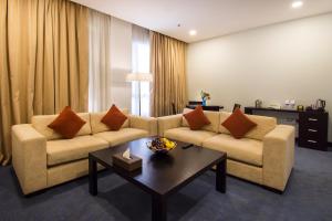 a living room filled with furniture and a couch at City Seasons Hotel & Suites Muscat in Muscat