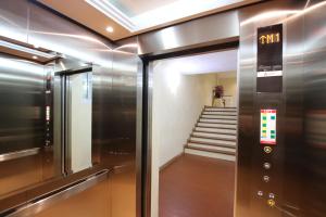 a elevator in a building with stairs in the background at Amphawaree in Samut Songkhram