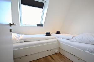 Postel nebo postele na pokoji v ubytování Villa Petersen, Penthouse 09