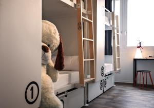 a white teddy bear sitting in a kitchen at Anda Venice Hostel in Mestre