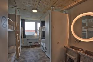 a bathroom with a sink, toilet and a mirror at Anda Venice Hostel in Mestre