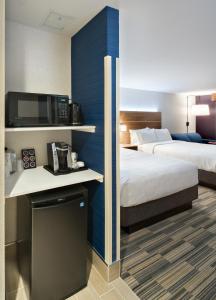 a hotel room with two beds and a tv at Holiday Inn Express - Red Deer North, an IHG Hotel in Red Deer