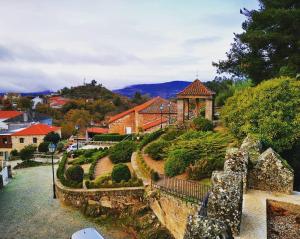 a view of a garden with a gazebo at Casa do Castelo in Sernancelhe