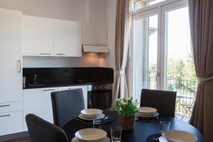 a kitchen with a table and chairs and a kitchen with a window at Residence Fiesole in Fiesole