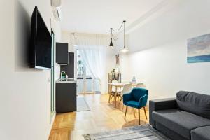 a living room with a couch and a table at Easylife - Milano - D'Annunzio - Navigli in Milan