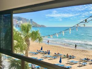 a view of the beach from a hotel window at Seafront Levante Beach Blueline in Benidorm